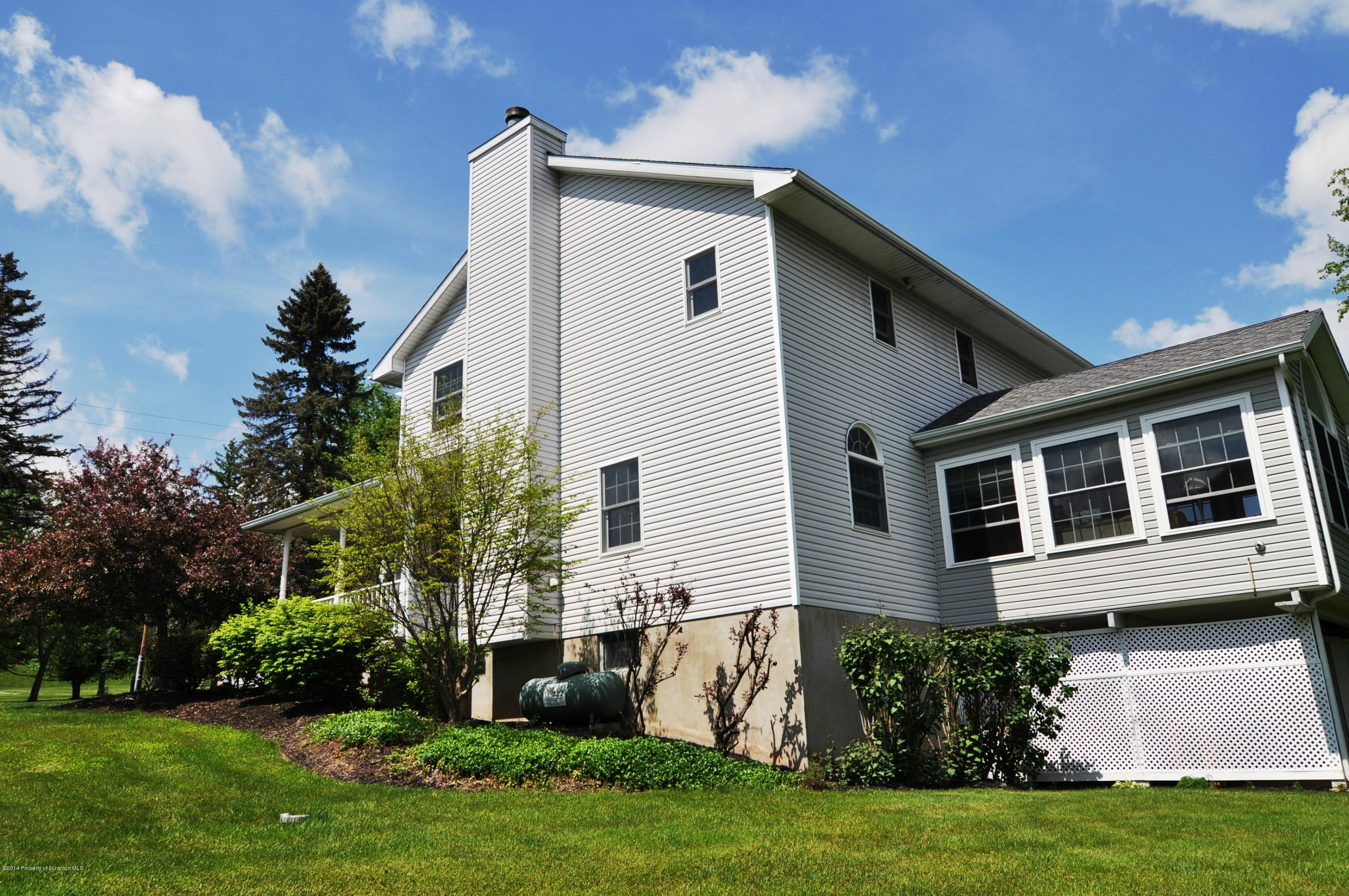 116 Griffin Road Moscow, PA 18444 - Photo 49 of 50 a front view of a house with a yard and potted plants
