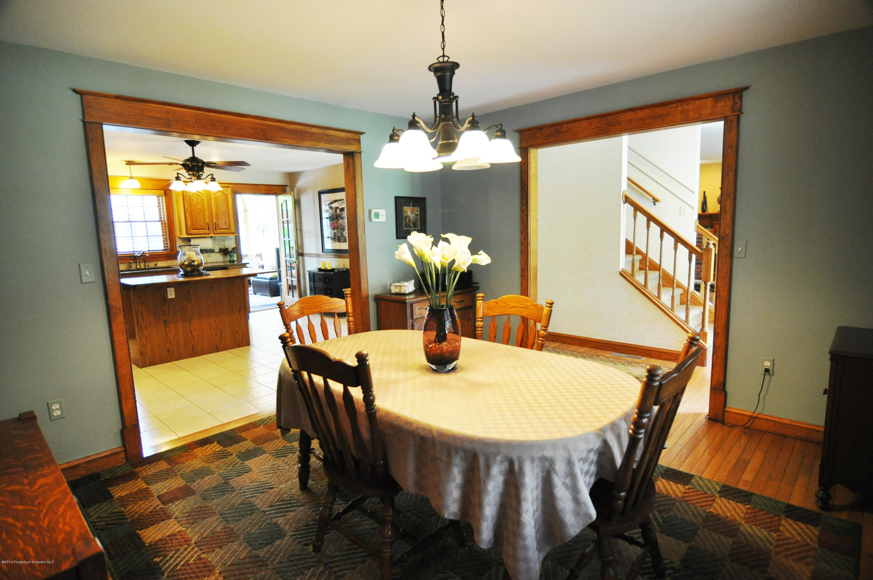 116 Griffin Road Moscow, PA 18444 - Photo 10 of 50 a dining room with furniture a chandelier and wooden floor