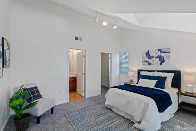 a bedroom with bed and a potted plant