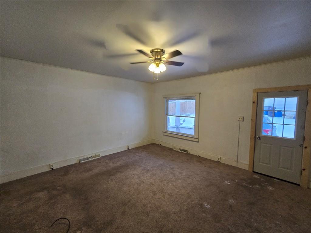 322 Chestnut Street Vandergrift, PA 15690 - Photo 2 of 8 an empty room with closet and a ceiling fan