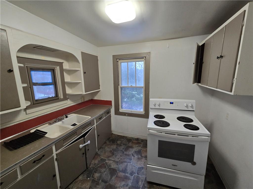 322 Chestnut Street Vandergrift, PA 15690 - Photo 3 of 8 a kitchen with a stove and a microwave