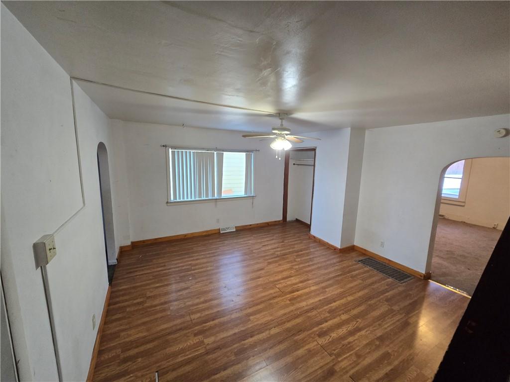 322 Chestnut Street Vandergrift, PA 15690 - Photo 4 of 8 a view of an empty room with wooden floor and a window