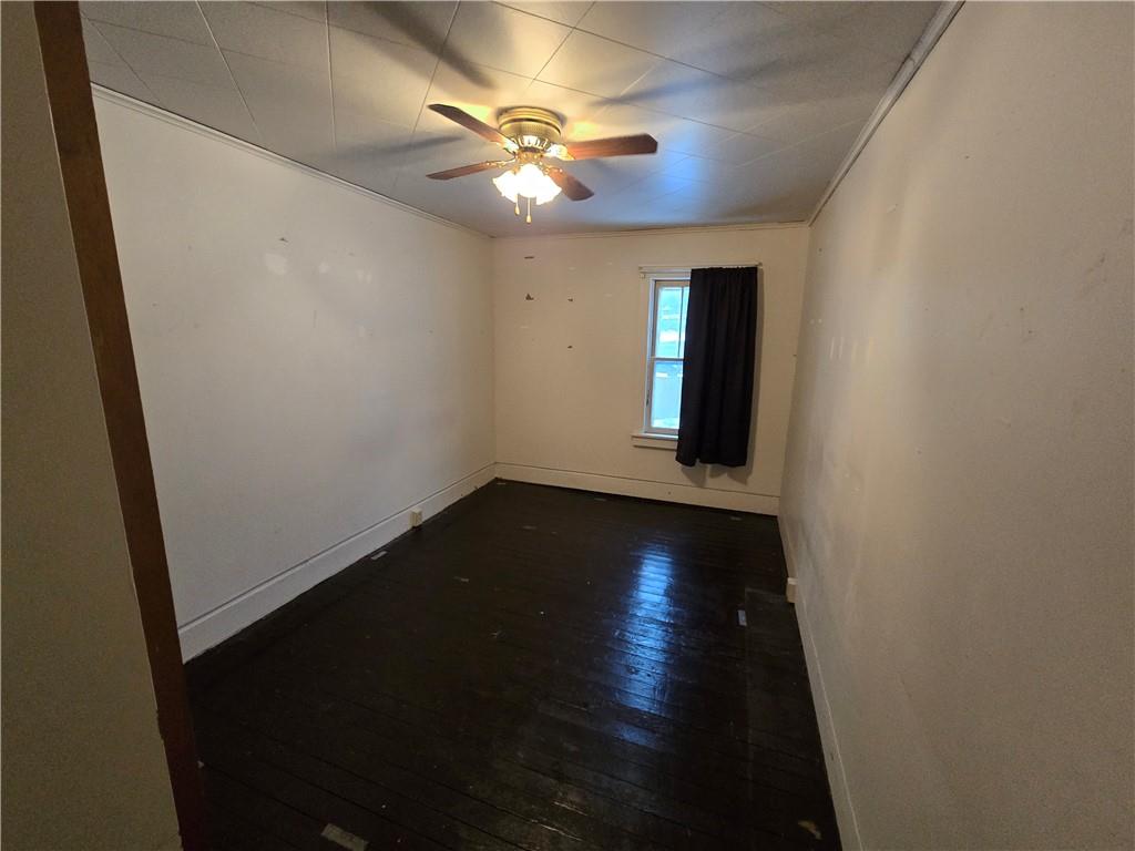 322 Chestnut Street Vandergrift, PA 15690 - Photo 5 of 8 wooden floor in an empty room with a window