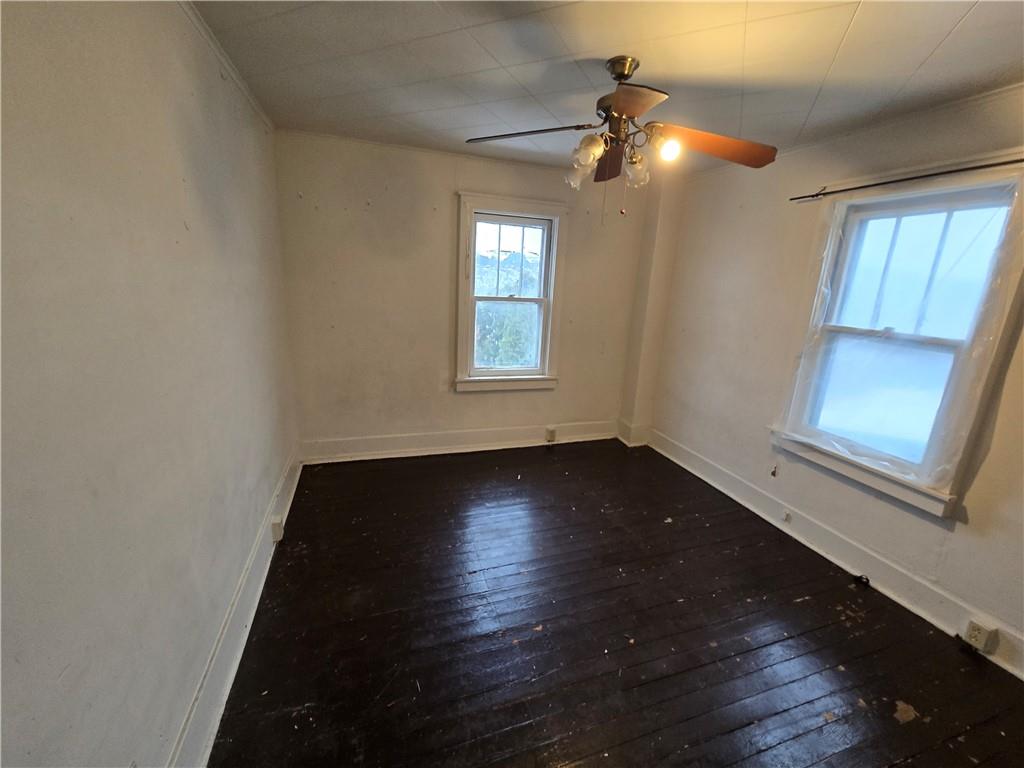 322 Chestnut Street Vandergrift, PA 15690 - Photo 6 of 8 an empty room with wooden floor and windows