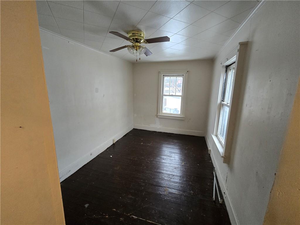 322 Chestnut Street Vandergrift, PA 15690 - Photo 8 of 8 a view of an empty room with wooden floor and a window