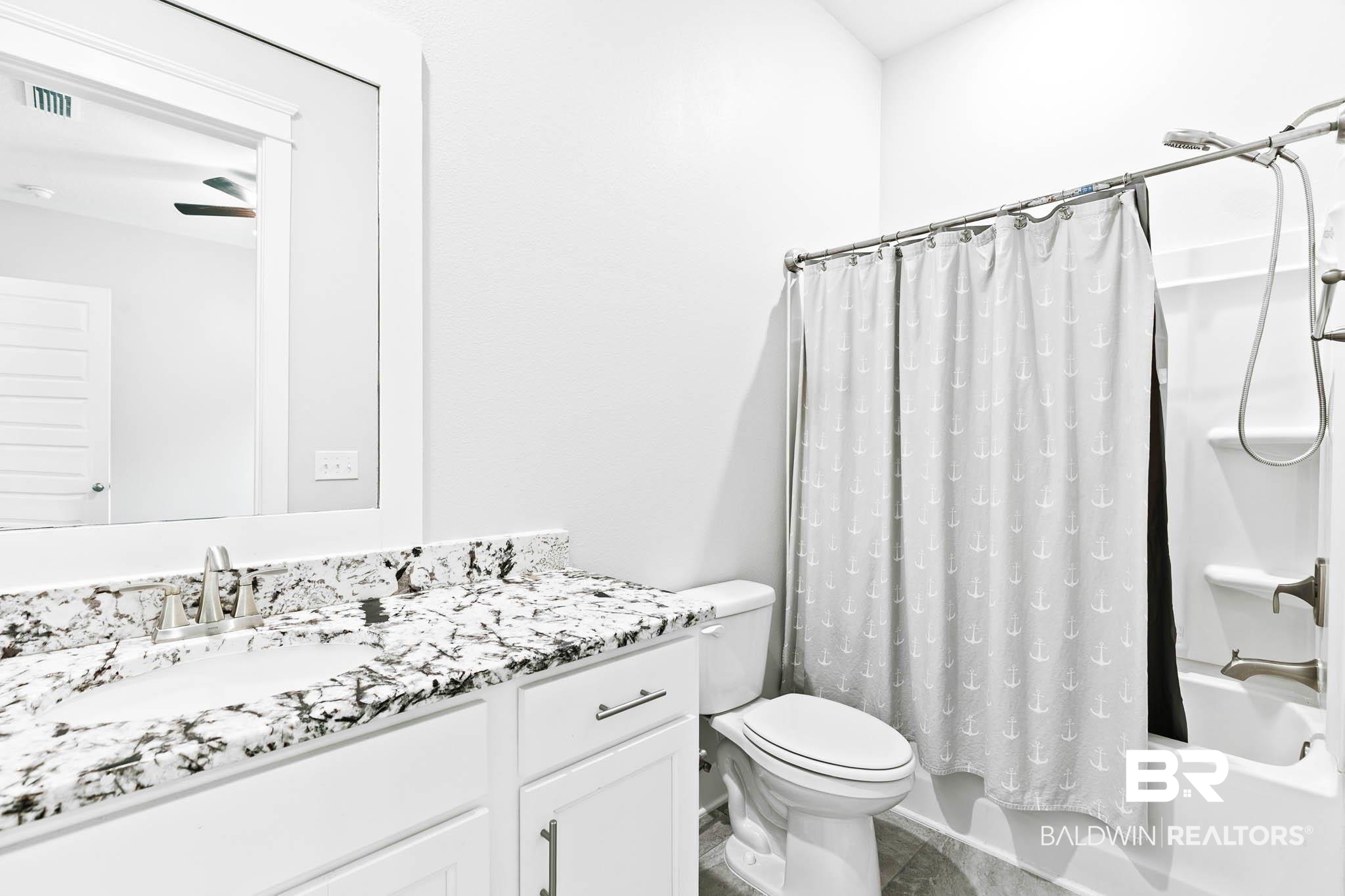 12785 Warbler Street Daphne, AL 36527 - Photo 20 of 53 Bathroom featuring shower / bath combo with shower curtain and vanity