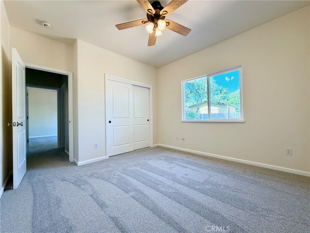 1037 Mark Twain Road Angels Camp, CA 95222 - Photo 41 of 52 an empty room with fan and windows