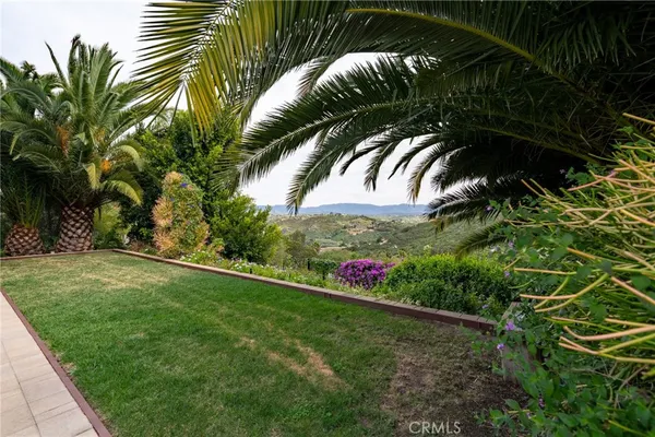 a large kitchen with stainless steel appliances kitchen island granite countertop a large counter top and a stove top oven