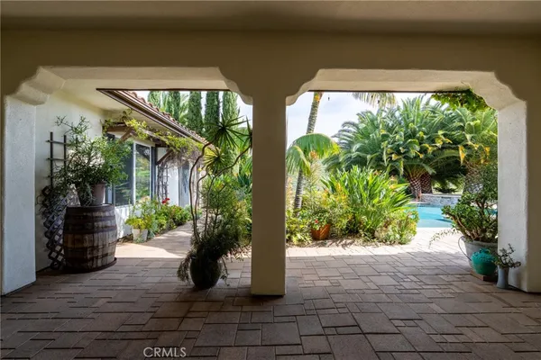 an empty room with wooden floor fireplace and windows
