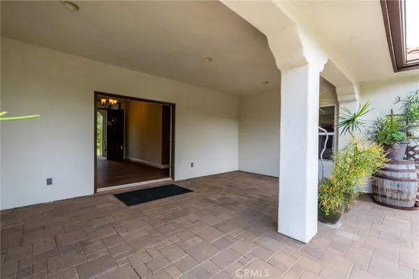 an empty room with wooden floor and fireplace