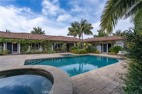 a view of a house with swimming pool and a porch