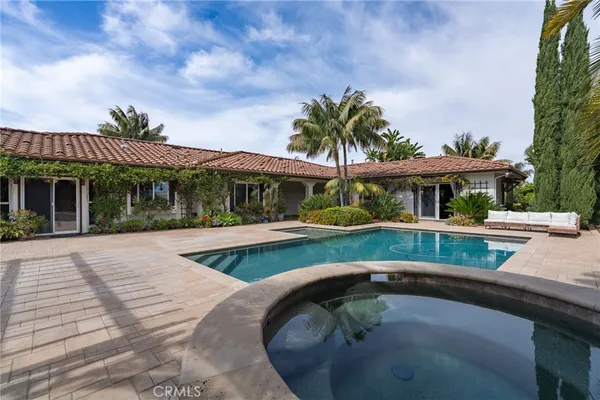 front view of house with large windows and a yard