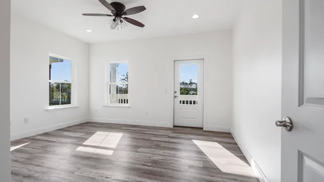 a view of a room with wooden floor and windows