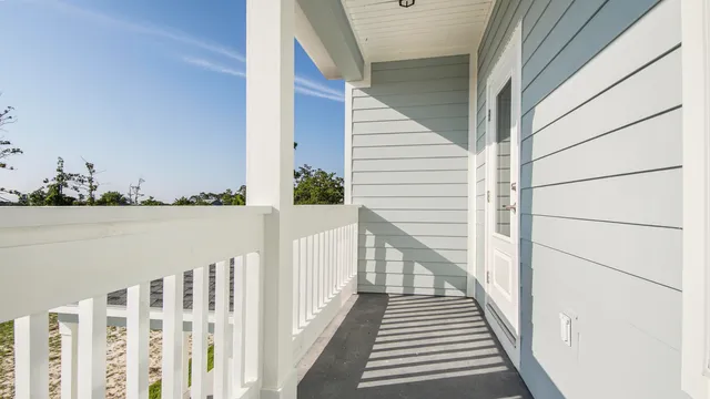 a view of a room with wooden floor and white walls