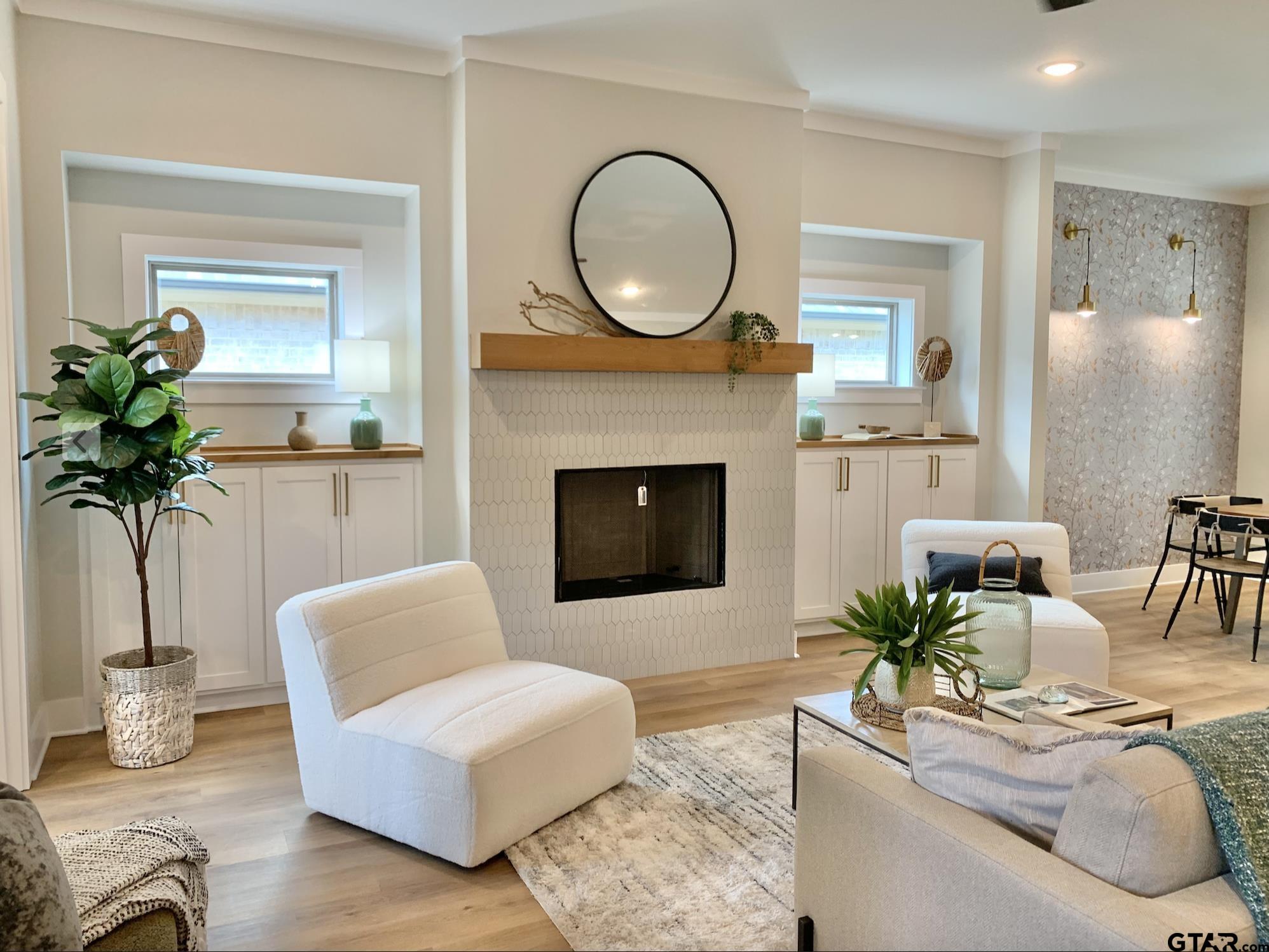 9115 Long Branch Tyler, TX 75703 - Photo 2 of 39 a living room with furniture a potted plant and a fireplace