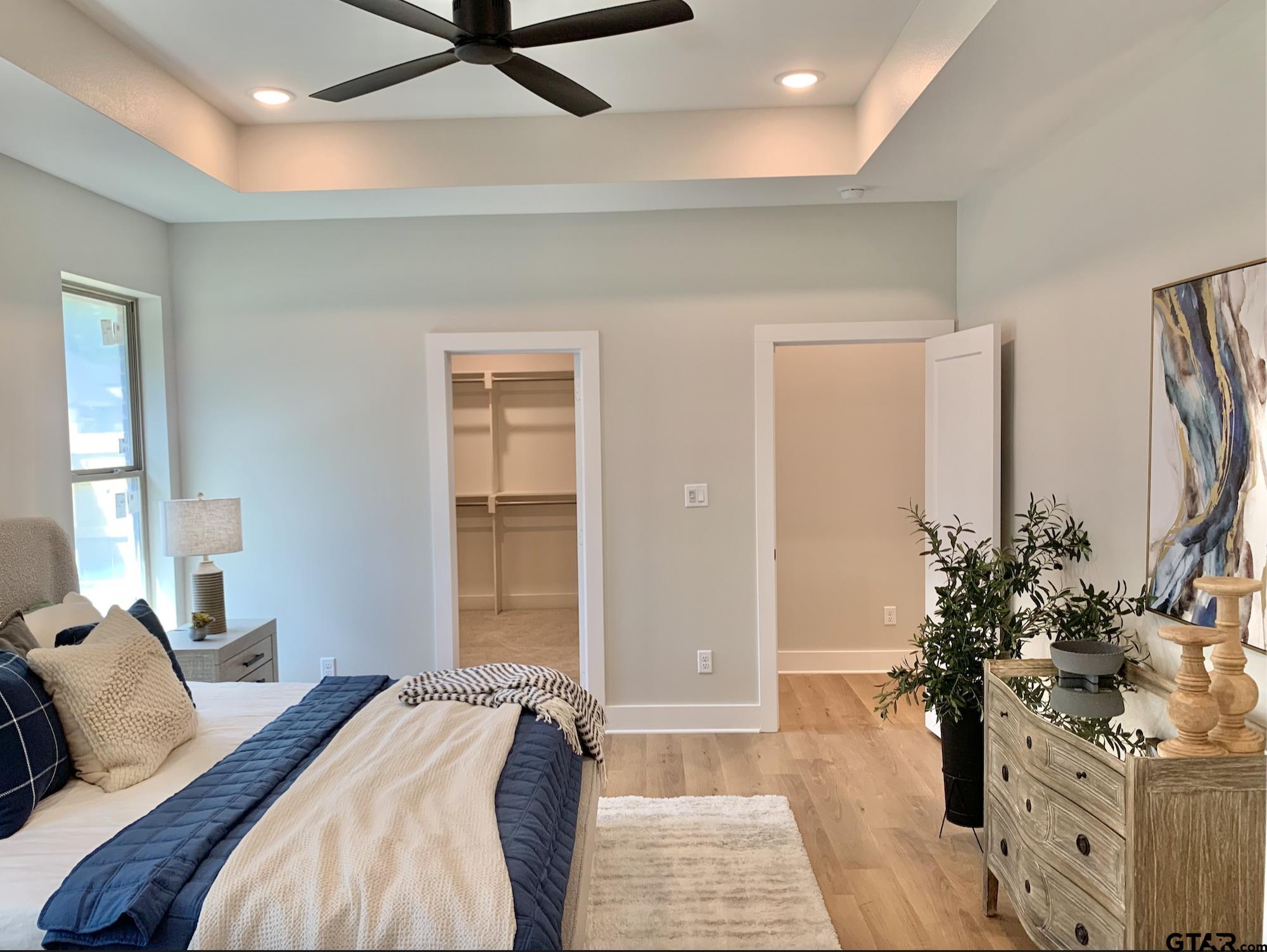 9115 Long Branch Tyler, TX 75703 - Photo 26 of 39 a bedroom with a bed table flowerpot and window