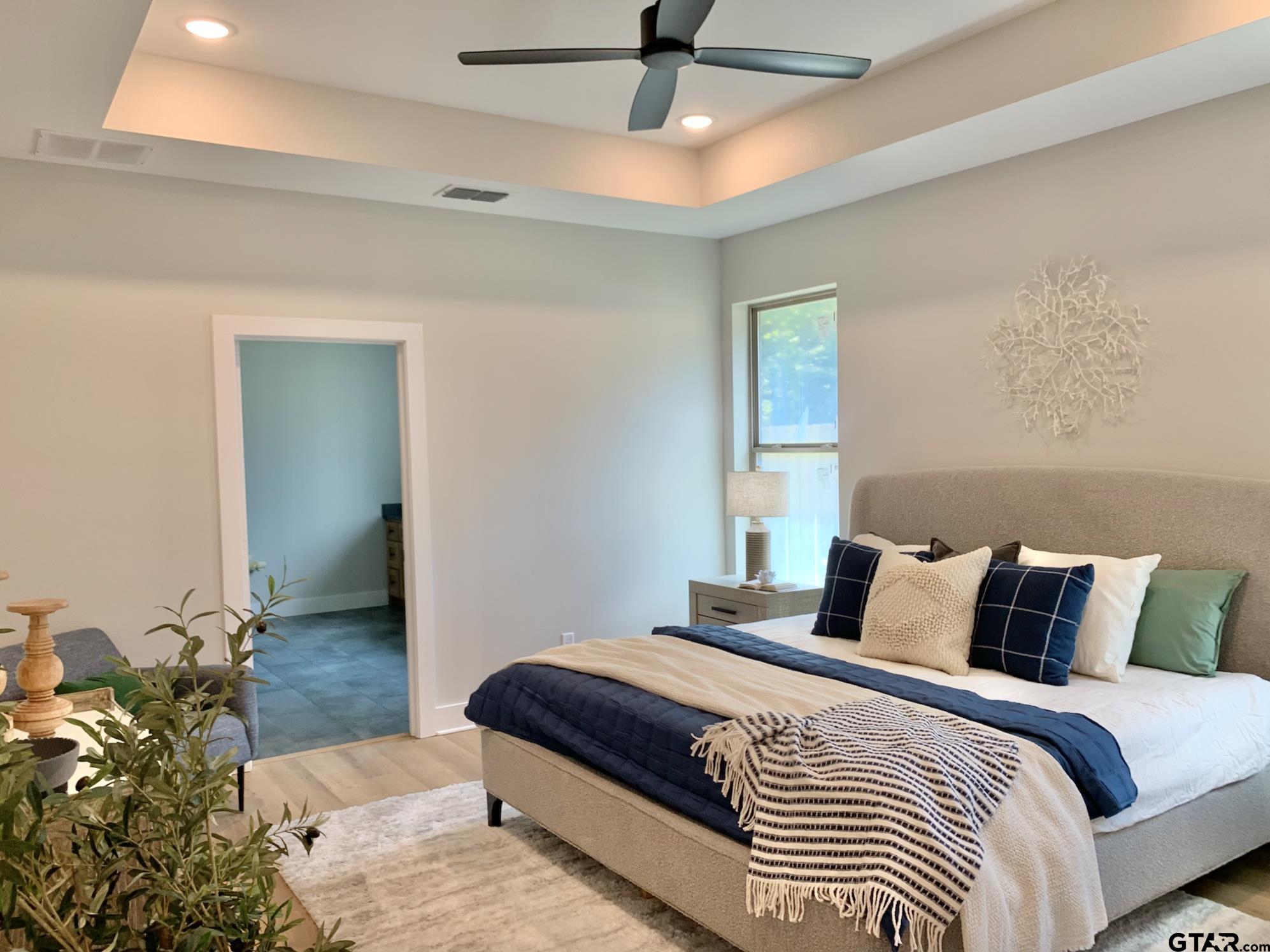 9115 Long Branch Tyler, TX 75703 - Photo 27 of 39 a bedroom with a bed and a potted plant
