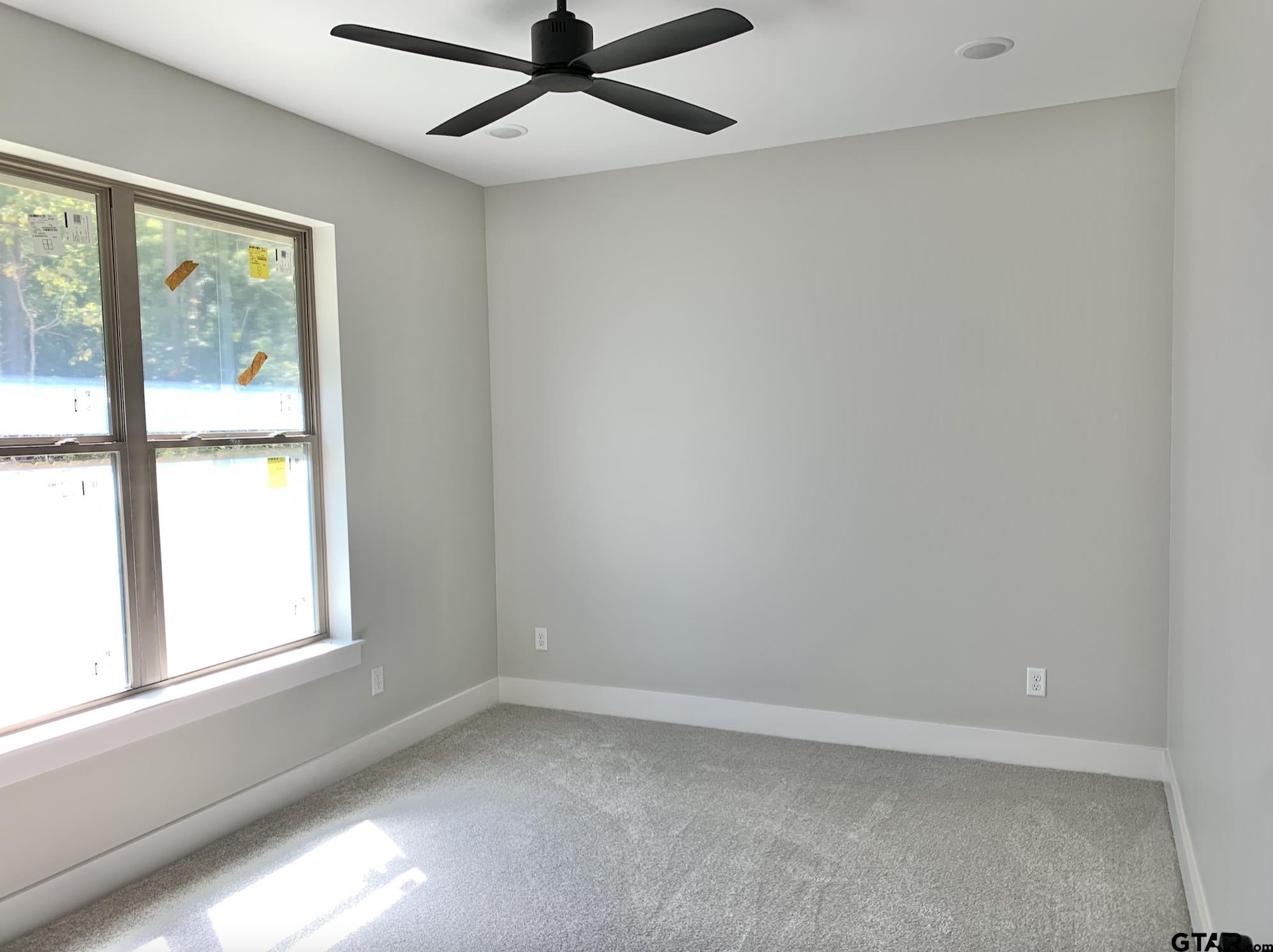 9115 Long Branch Tyler, TX 75703 - Photo 34 of 39 an empty room with a window and a fan