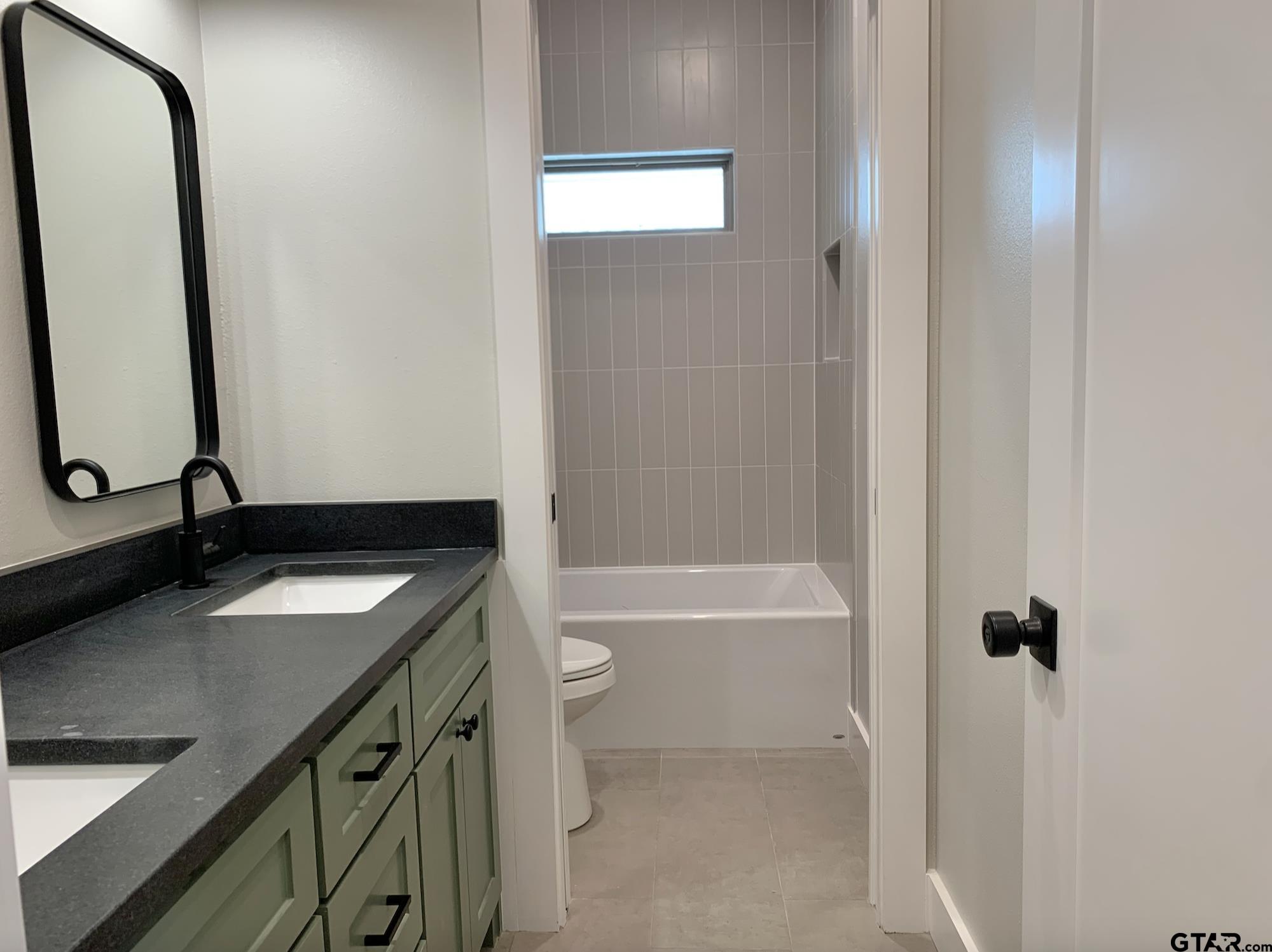 9115 Long Branch Tyler, TX 75703 - Photo 35 of 39 a bathroom with a sink vanity tub and a mirror