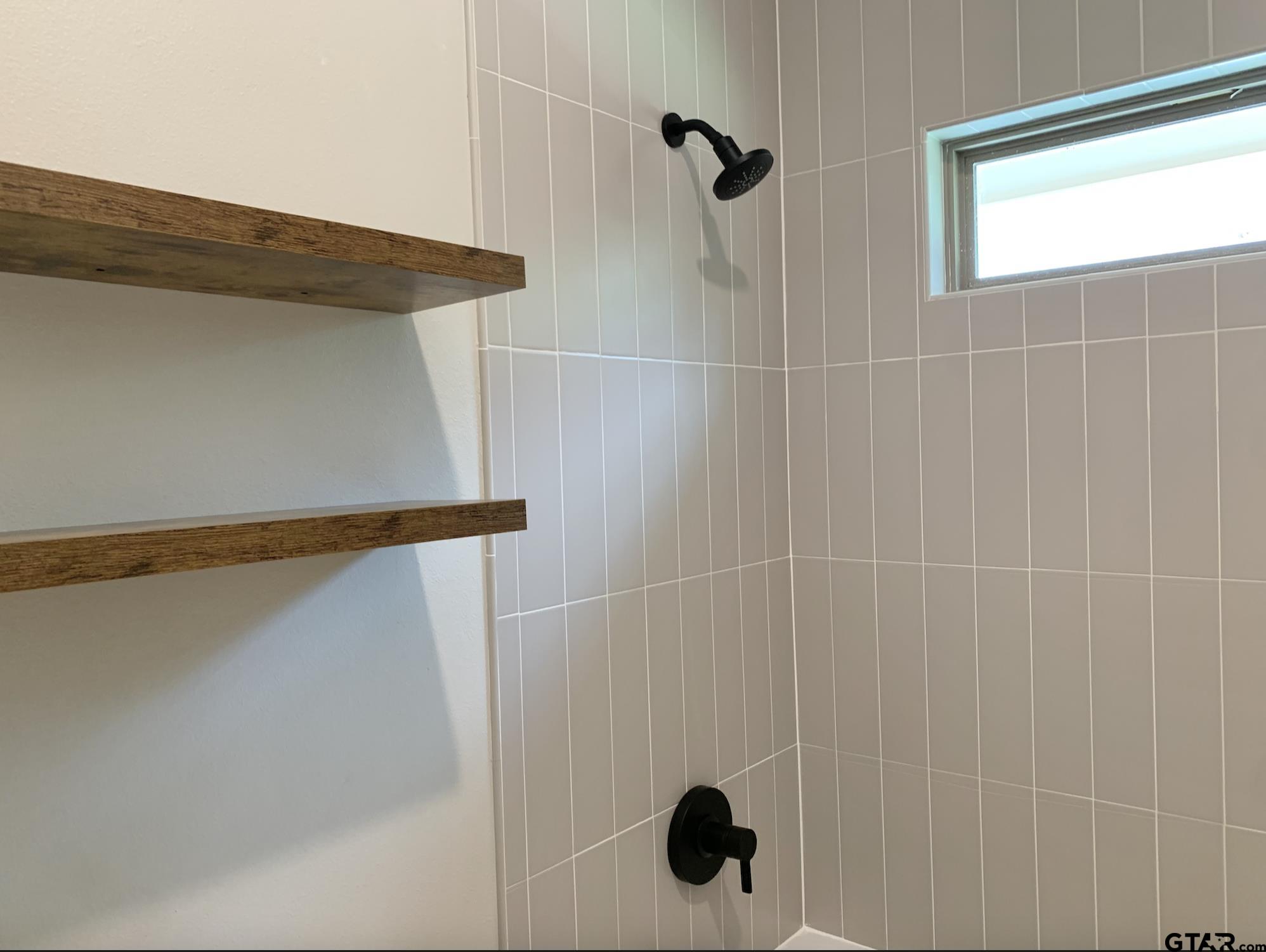 9115 Long Branch Tyler, TX 75703 - Photo 36 of 39 a bathroom with a shower and a window