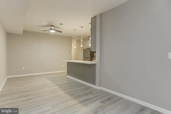 a view of a kitchen with a sink and wooden floor
