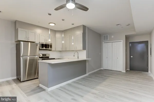 a kitchen with stainless steel appliances a refrigerator sink and microwave