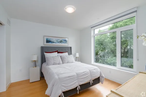 a bedroom with a large bed and a large window