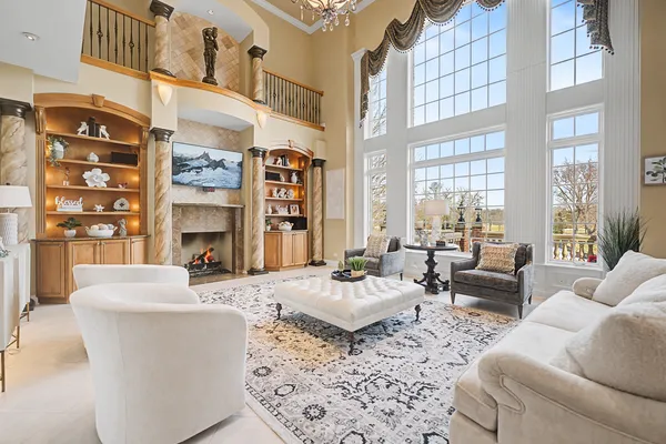 a kitchen with stainless steel appliances kitchen island granite countertop a table chairs and a refrigerator