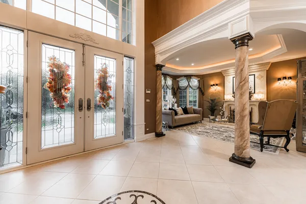 a living room with fireplace furniture and a large window