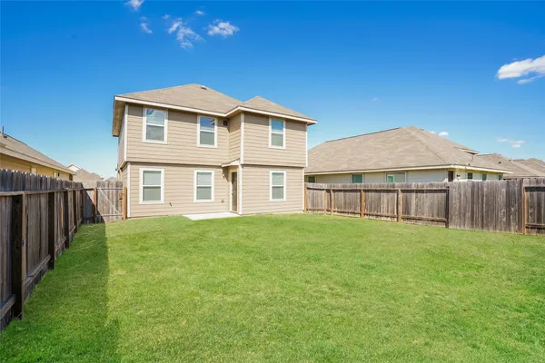 a big house with a big yard and more large trees