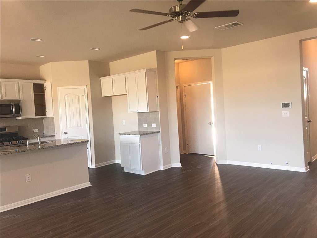 4313 Buffalo Ford Road Georgetown, TX 78628 - Photo 12 of 36 a view of a kitchen with wooden floor and a kitchen