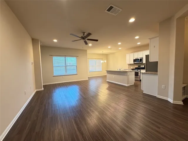 a view of kitchen with cabinets and wooden floor