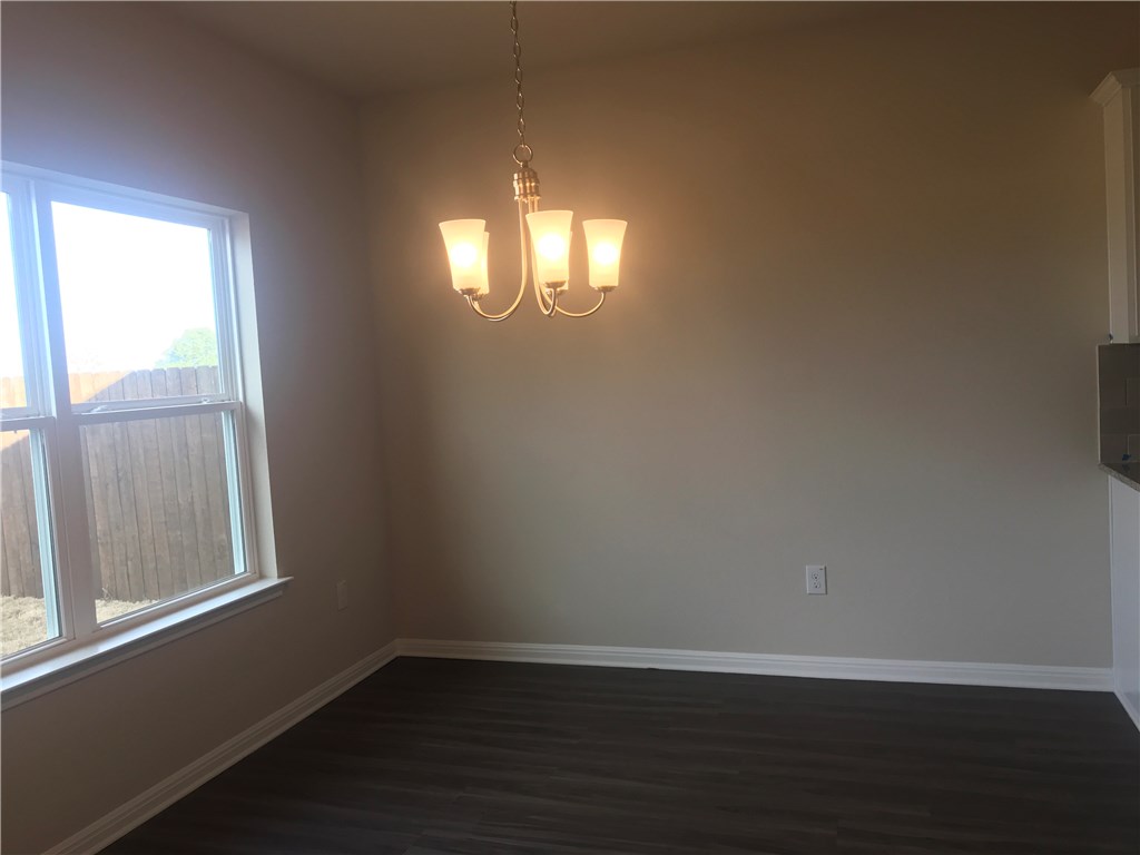 4313 Buffalo Ford Road Georgetown, TX 78628 - Photo 10 of 36 an empty room with wooden floor and windows