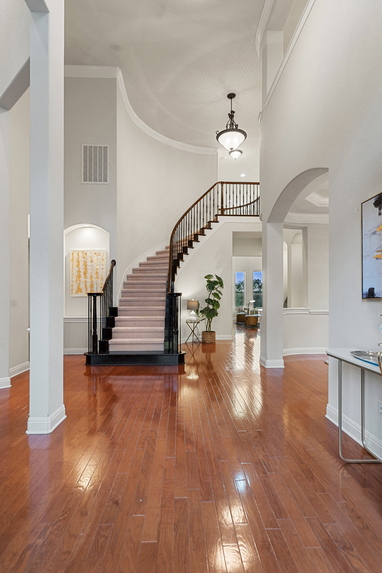 2906 Lakehurst Road Spicewood, TX 78669 - Photo 11 of 40 a view of a hallway with wooden floor staircase and a living room