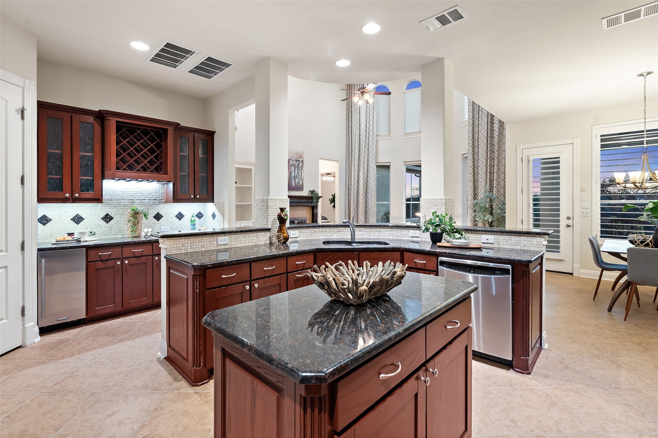 2906 Lakehurst Road Spicewood, TX 78669 - Photo 17 of 40 a kitchen with a sink stove and chairs