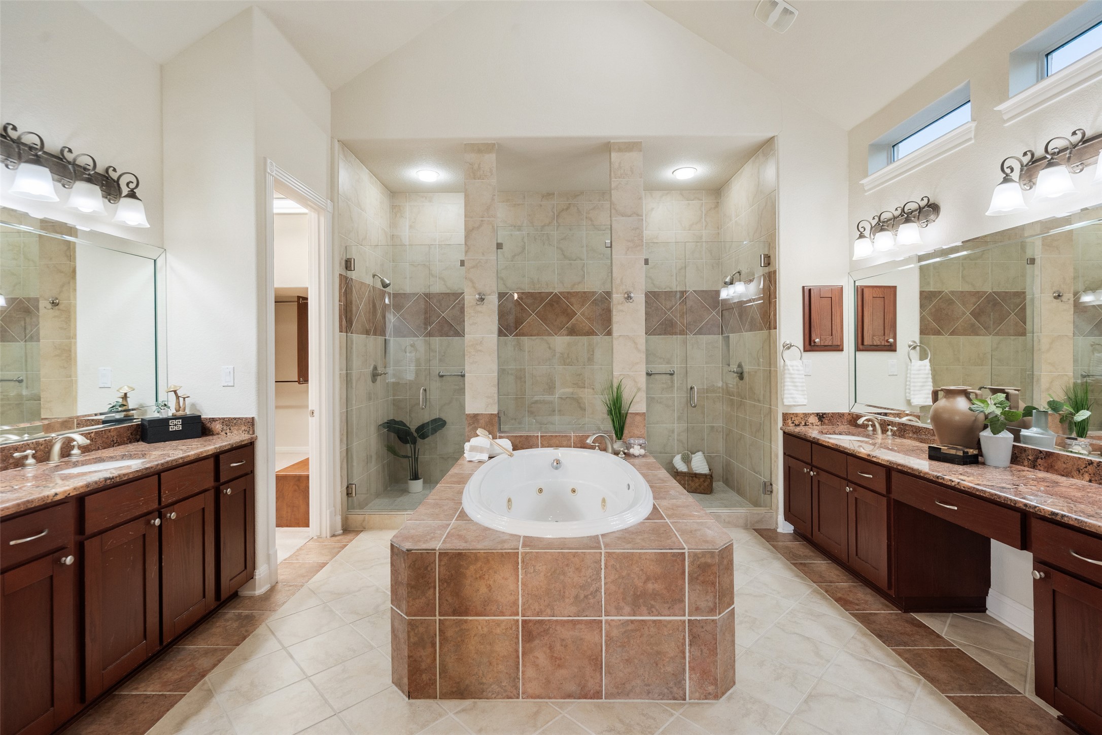 2906 Lakehurst Road Spicewood, TX 78669 - Photo 23 of 40 a spacious bathroom with a tub sink shower and mirror