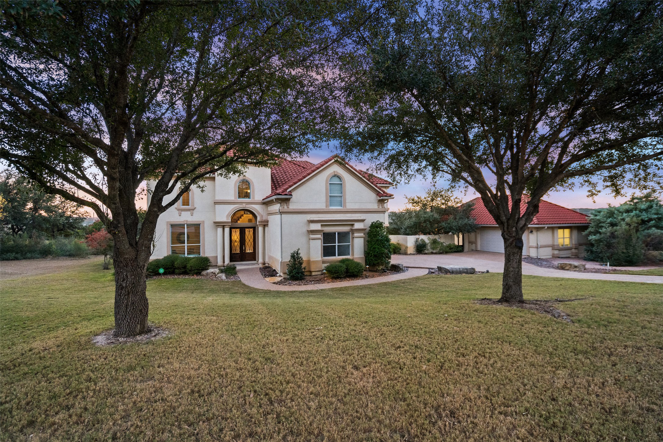 2906 Lakehurst Road Spicewood, TX 78669 - Photo 3 of 40 a front view of a house with a yard and tree