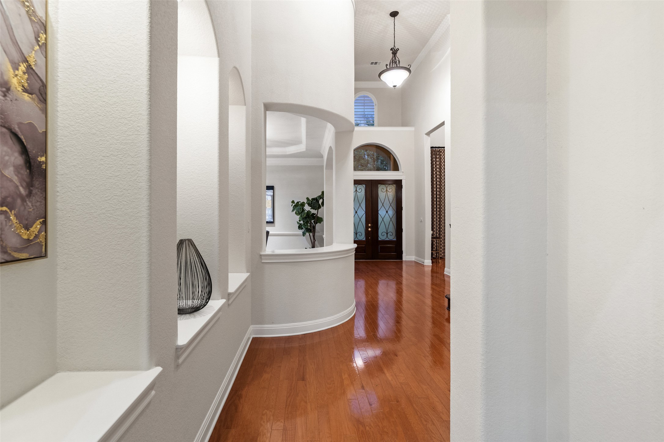 2906 Lakehurst Road Spicewood, TX 78669 - Photo 10 of 40 a view of a hallway with wooden floor and staircase