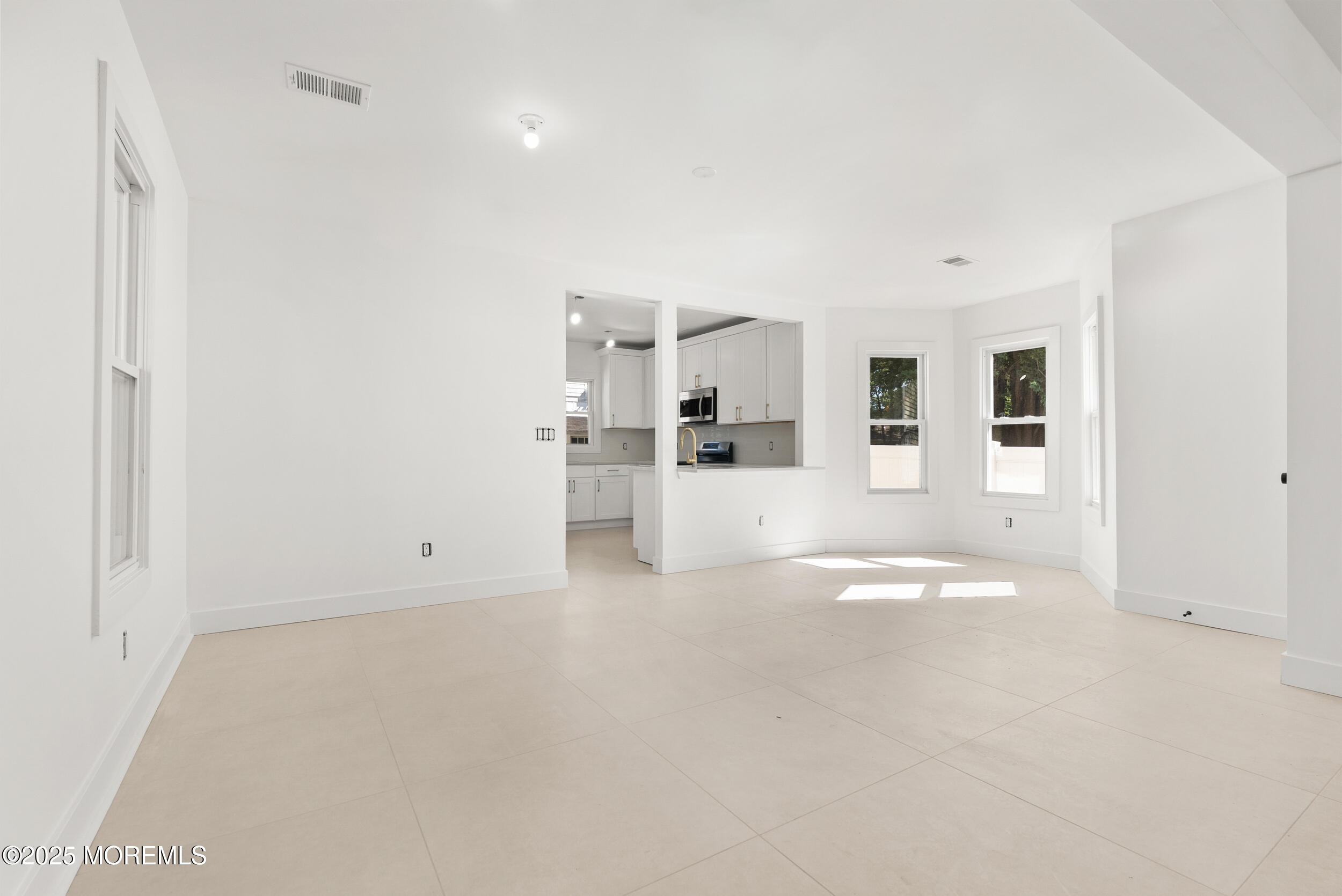 448 Monmouth Road West Long Branch, NJ 07764 - Photo 11 of 35 a view of empty room with wooden floor and windows