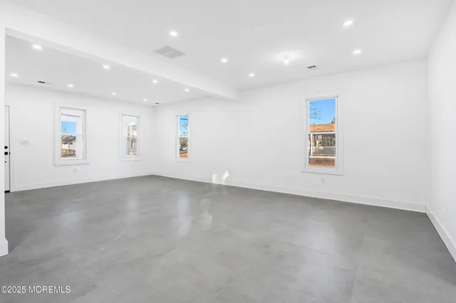 a bathroom with a sink a toilet a mirror and shower