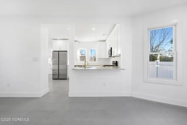 a view of room with hardwood ceiling fan