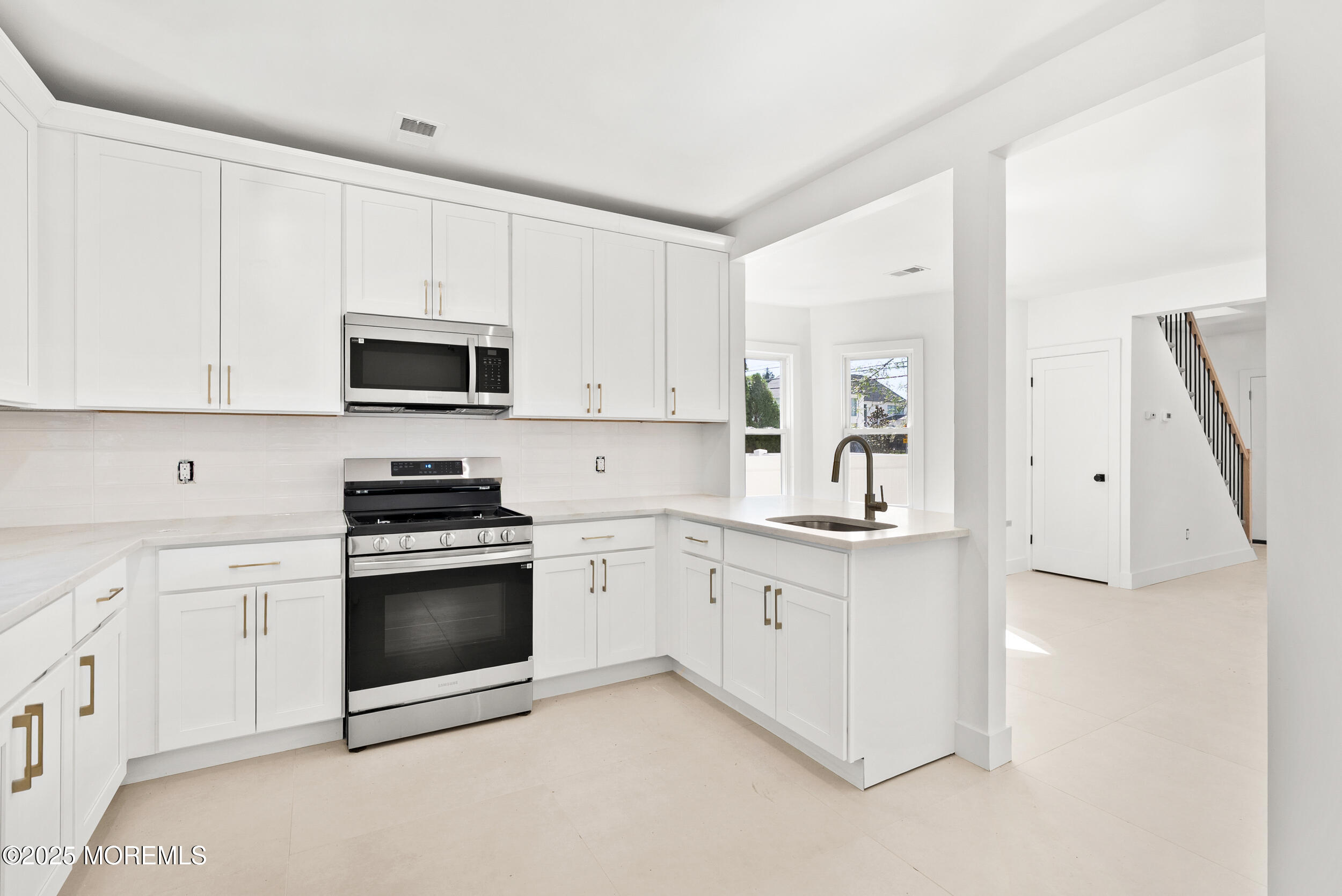 448 Monmouth Road West Long Branch, NJ 07764 - Photo 16 of 35 a kitchen with granite countertop white cabinets sink and stainless steel appliances