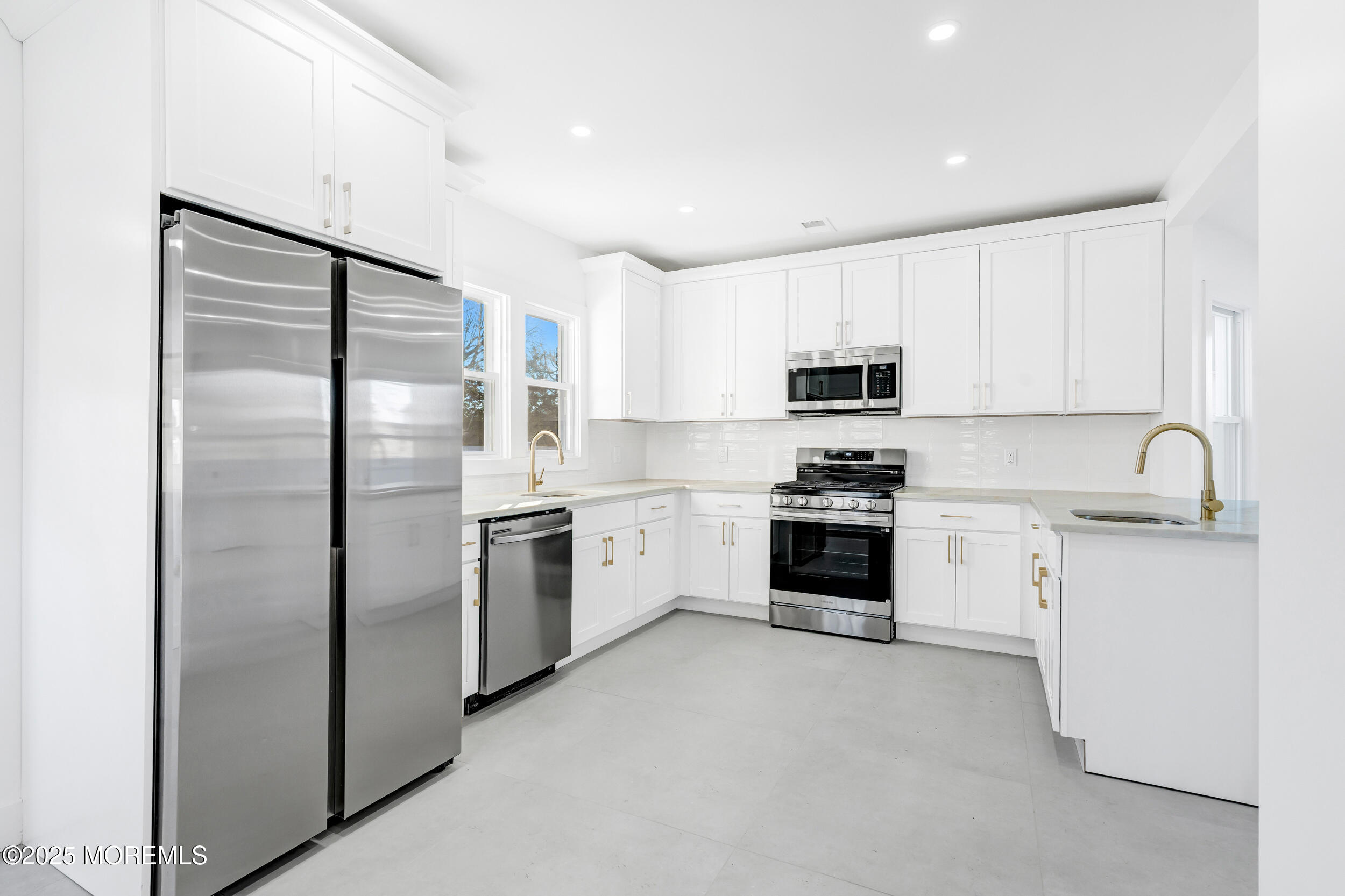 448 Monmouth Road West Long Branch, NJ 07764 - Photo 18 of 51 a kitchen with granite countertop white cabinets and stainless steel appliances