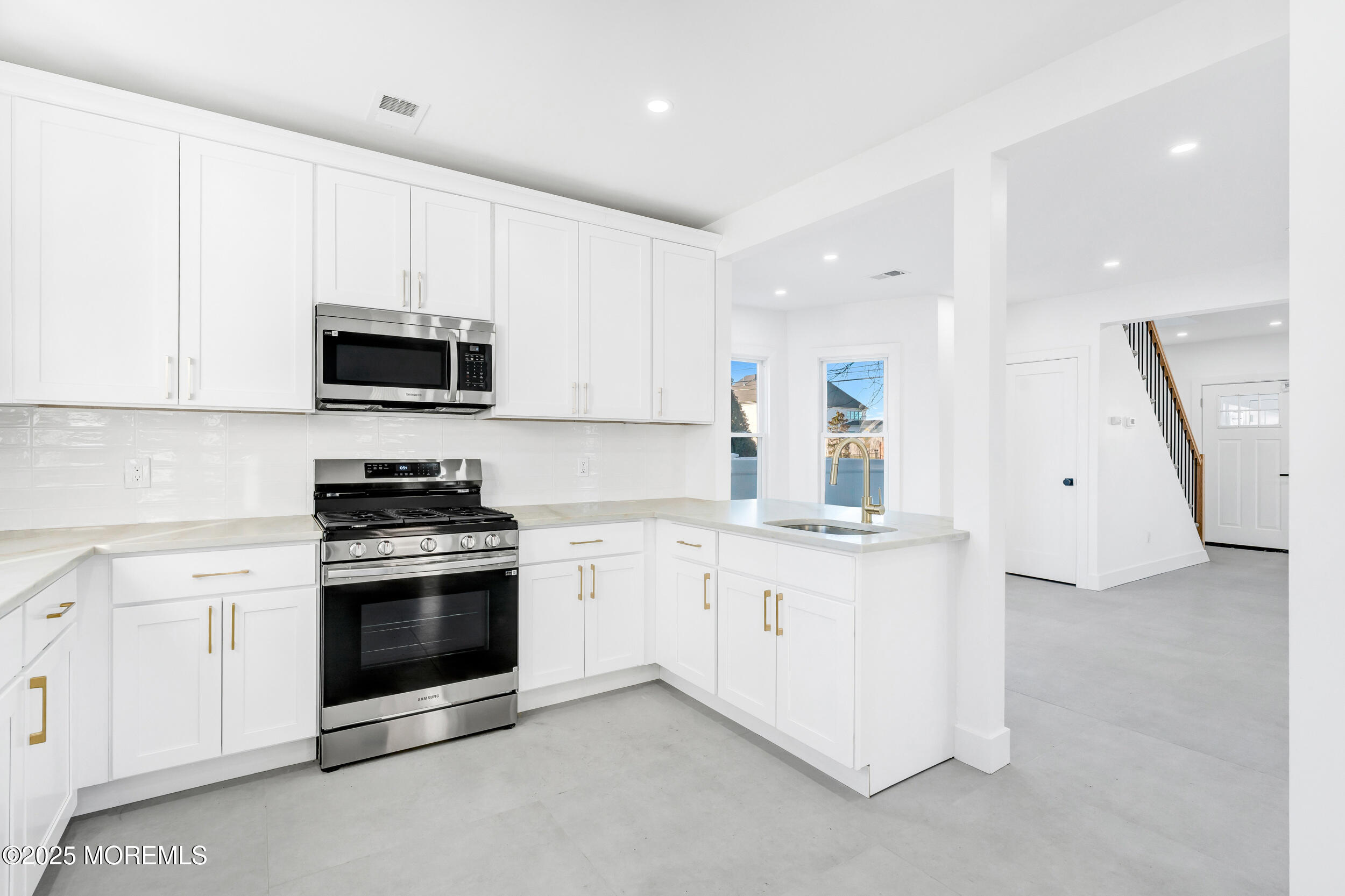 448 Monmouth Road West Long Branch, NJ 07764 - Photo 19 of 51 a kitchen with stainless steel appliances granite countertop a stove a sink and a microwave