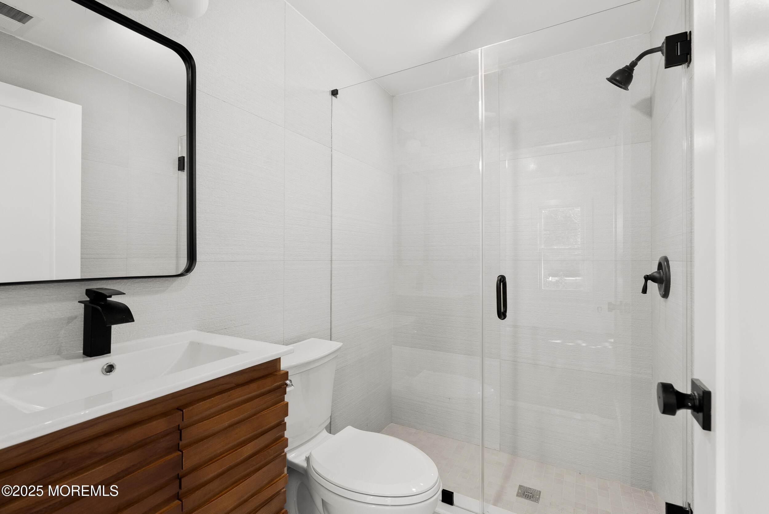 448 Monmouth Road West Long Branch, NJ 07764 - Photo 22 of 35 a bathroom with a sink a toilet a mirror and shower