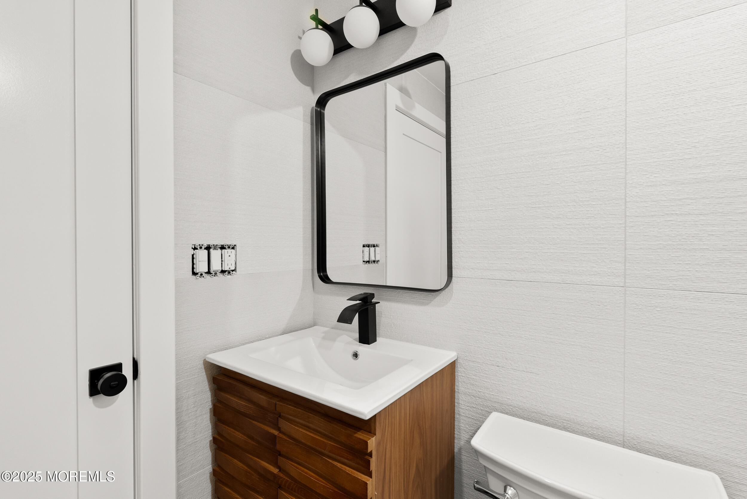 448 Monmouth Road West Long Branch, NJ 07764 - Photo 29 of 35 a bathroom with a toilet sink and mirror