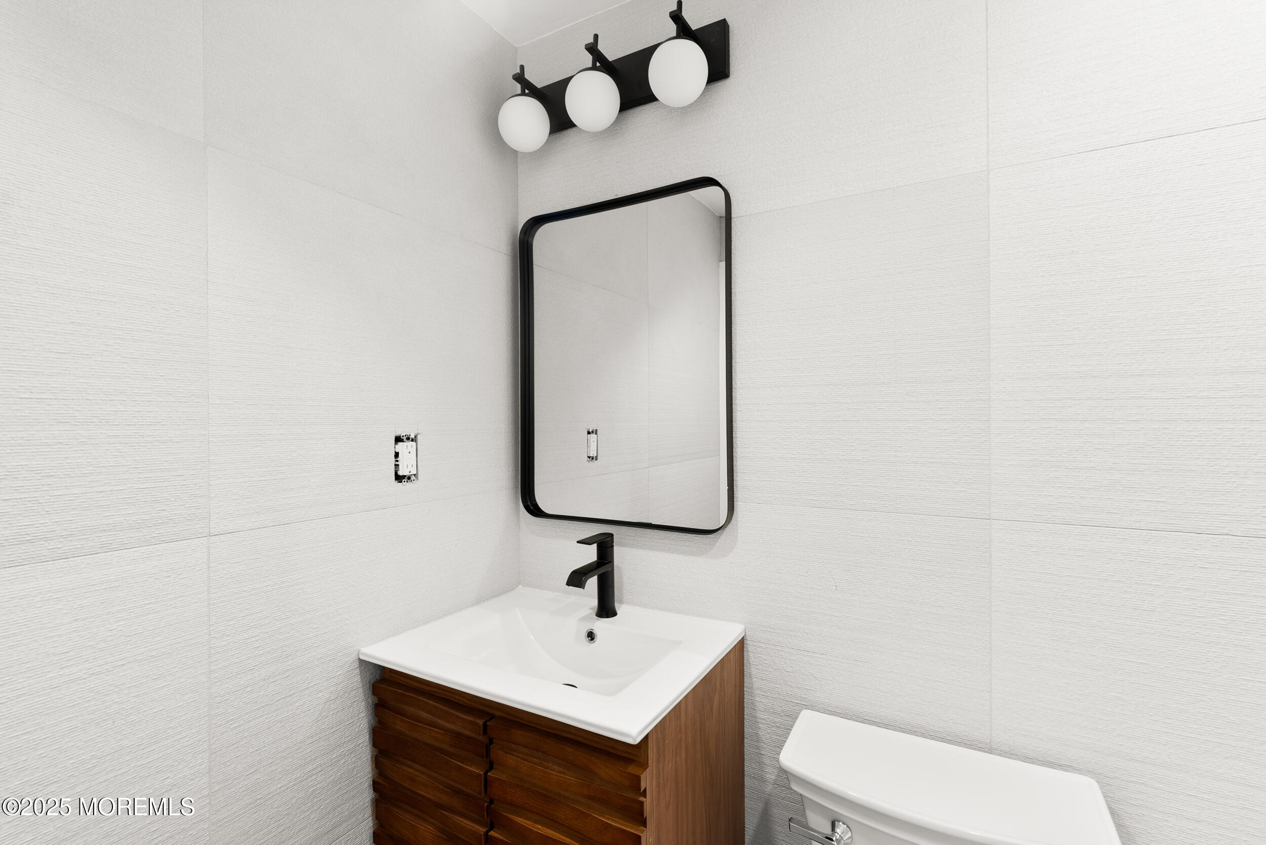448 Monmouth Road West Long Branch, NJ 07764 - Photo 30 of 35 a bathroom with a toilet sink and mirror