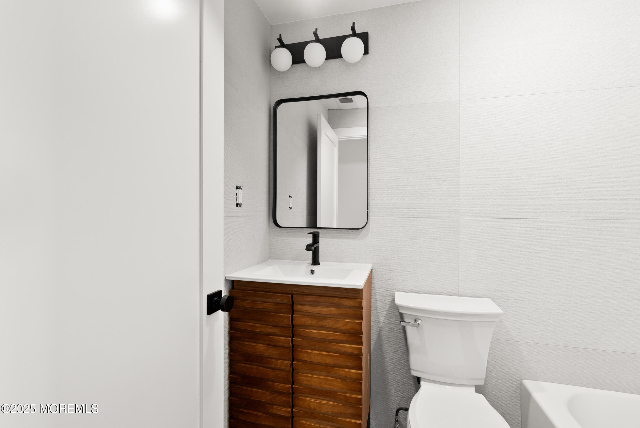 448 Monmouth Road West Long Branch, NJ 07764 - Photo 31 of 35 a bathroom with a toilet sink and mirror