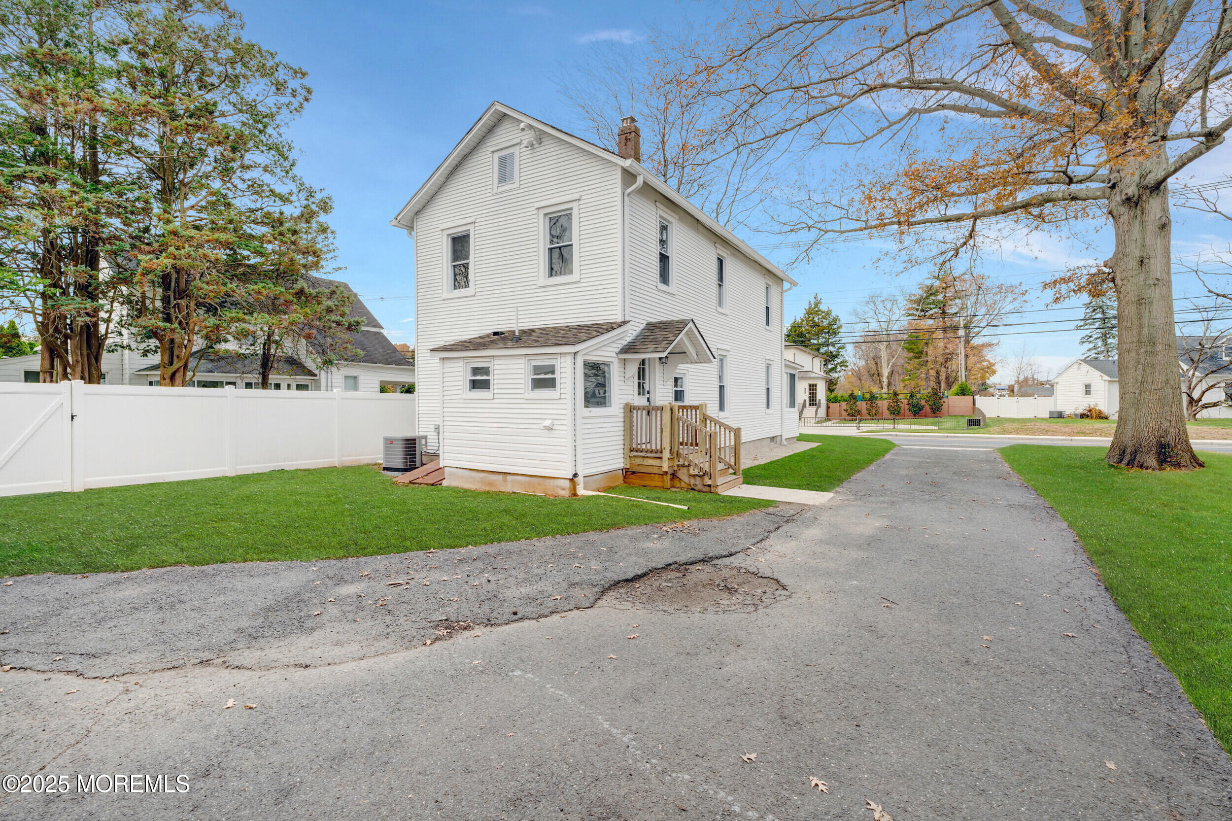 448 Monmouth Road West Long Branch, NJ 07764 - Photo 32 of 35 a view of a white house with a yard and a large tree