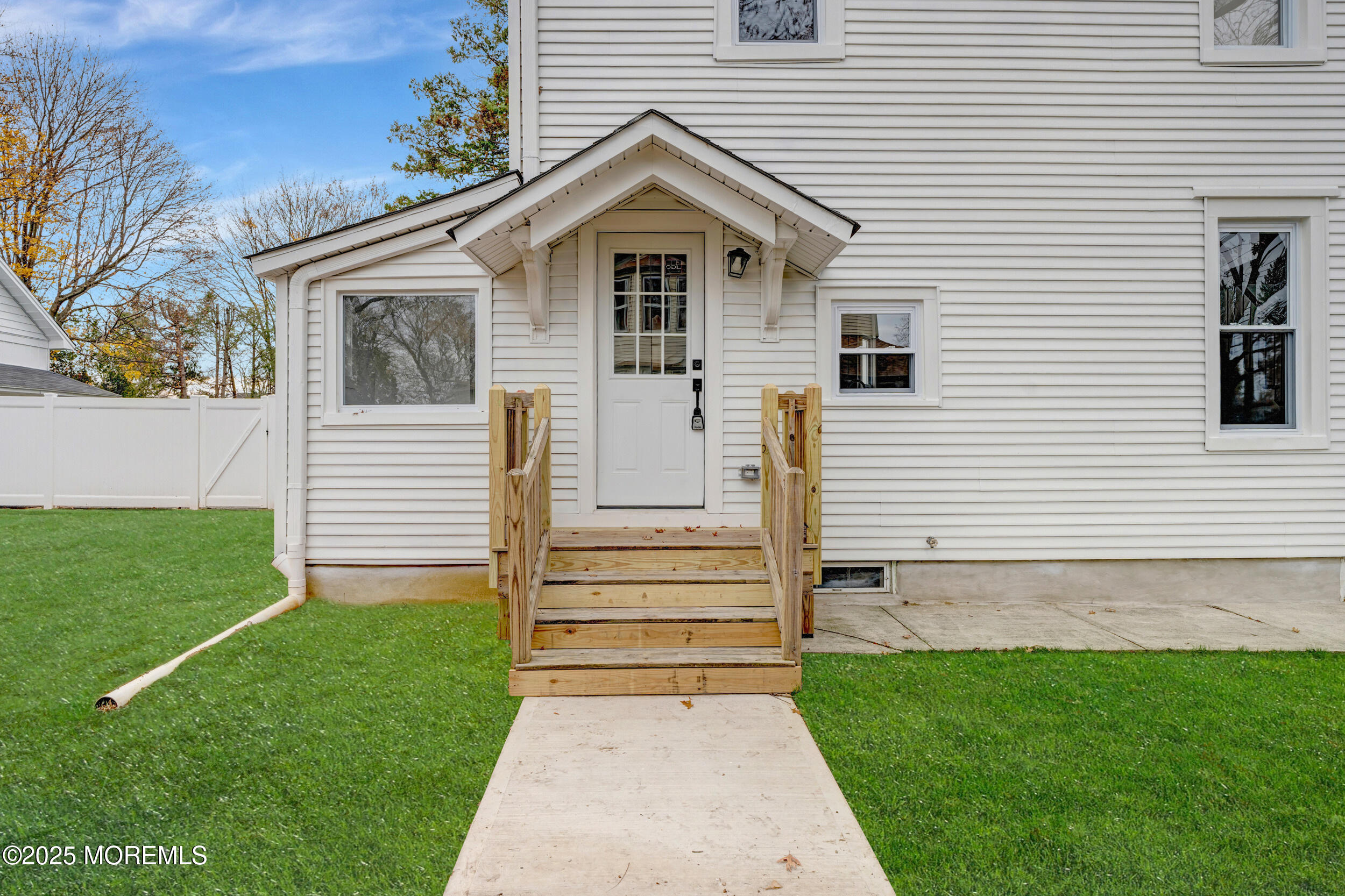 448 Monmouth Road West Long Branch, NJ 07764 - Photo 33 of 35 a view of a white house with a small yard and a large tree